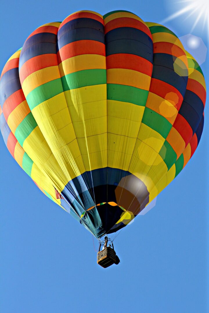 A colorful hot air balloon flying in the sky.