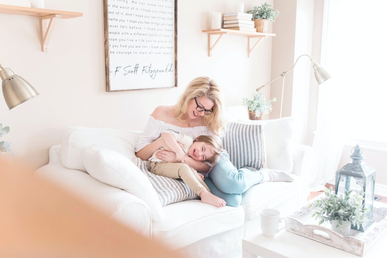 A woman and child sitting on the couch