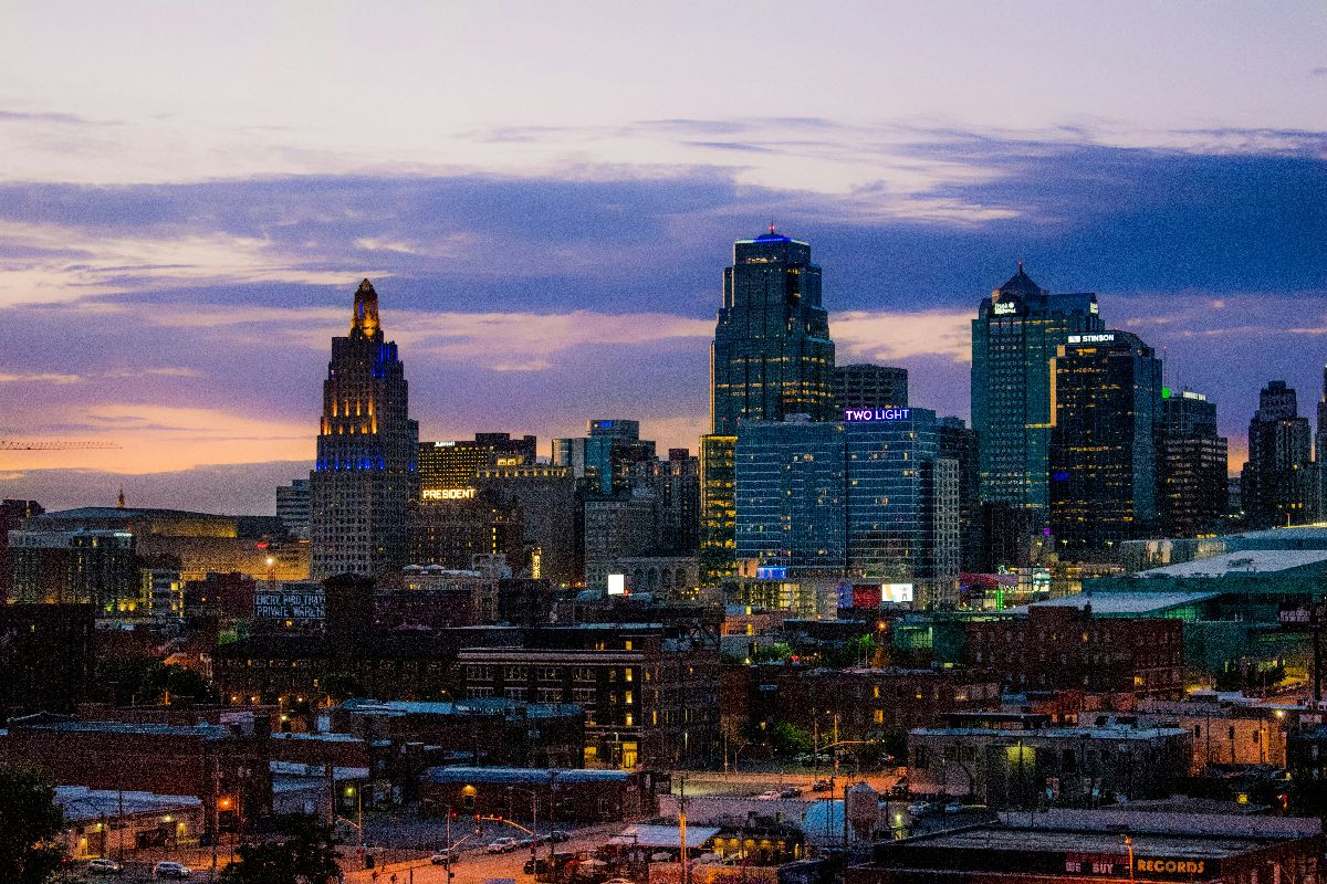 City skyline at dusk with colorful lights.