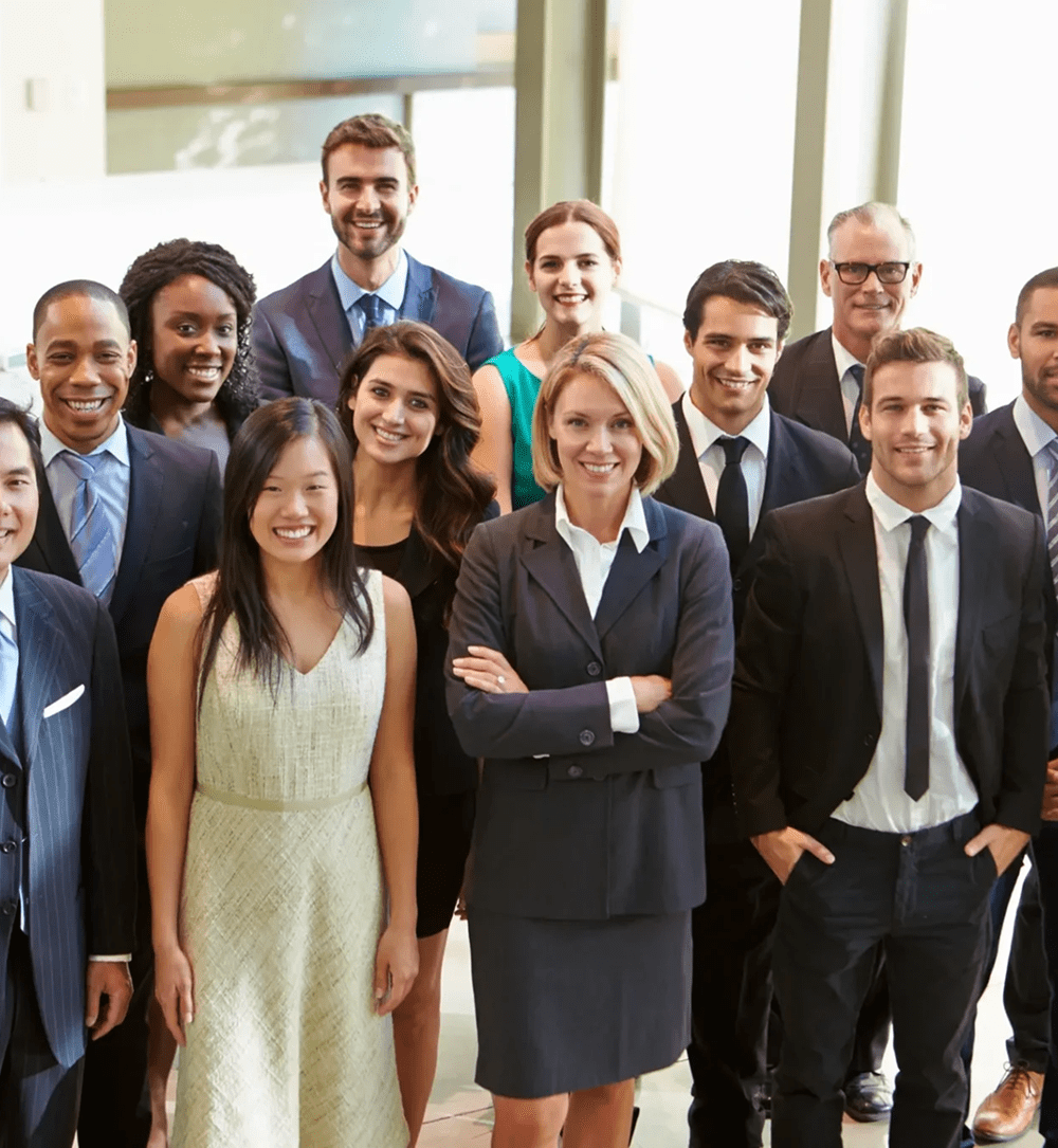 Group of professionals smiling in office setting.