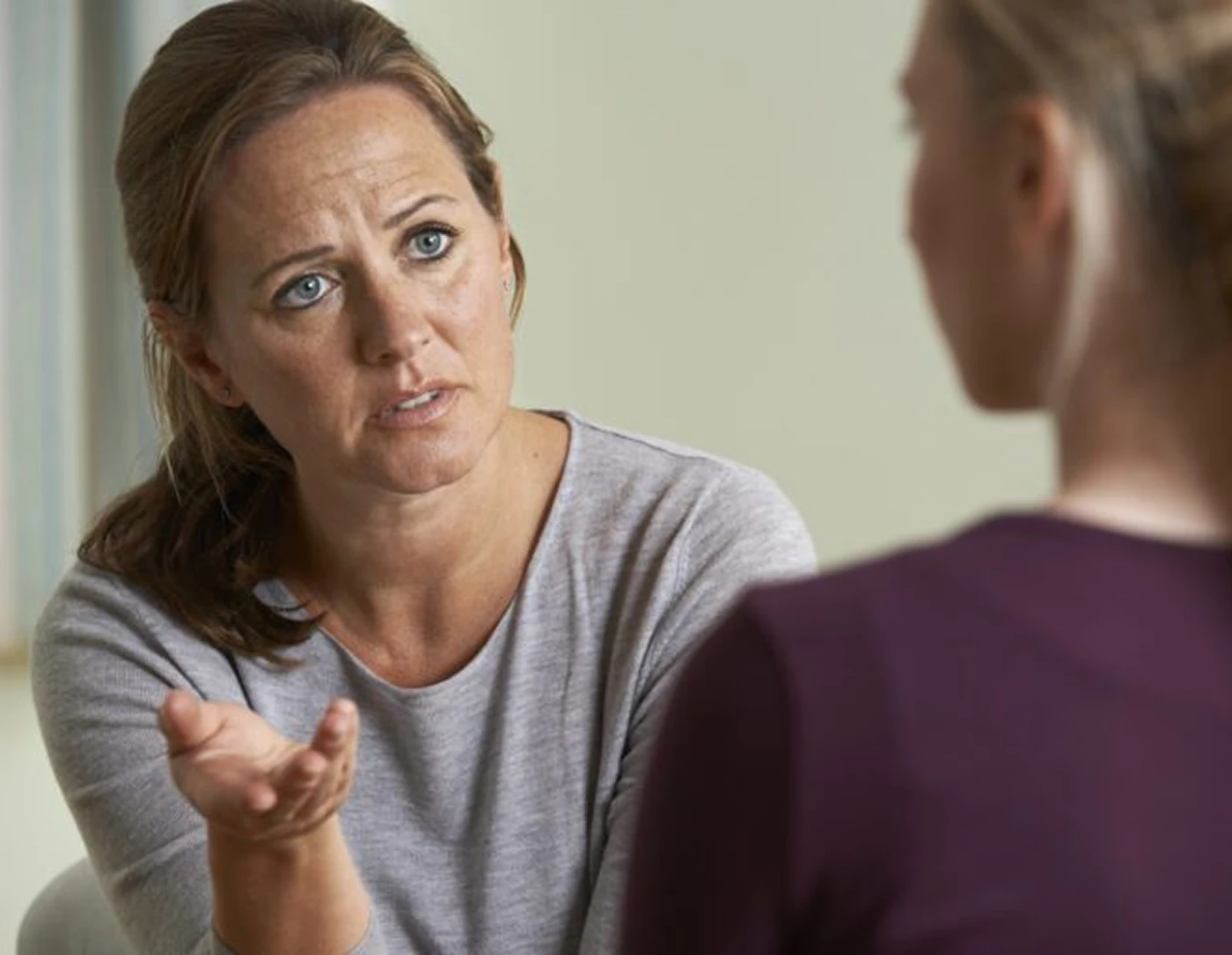 Two women engaged in serious conversation.
