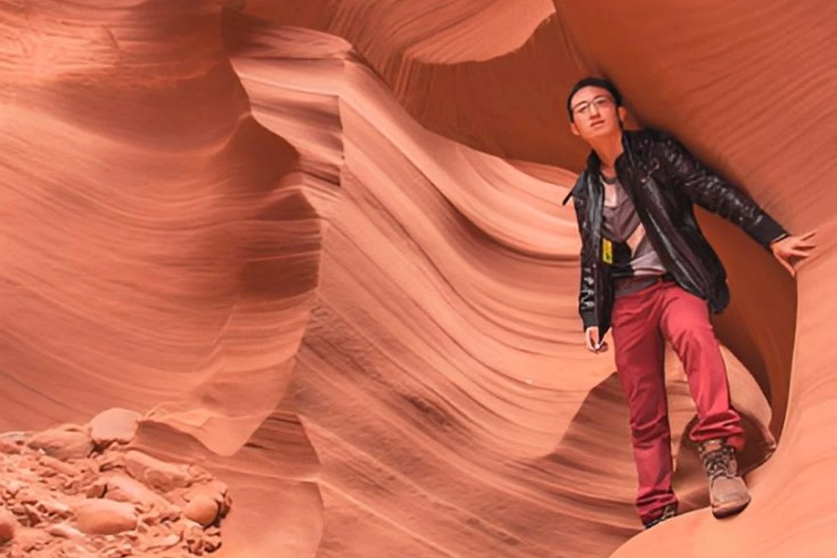 Person posing in a red canyon landscape.