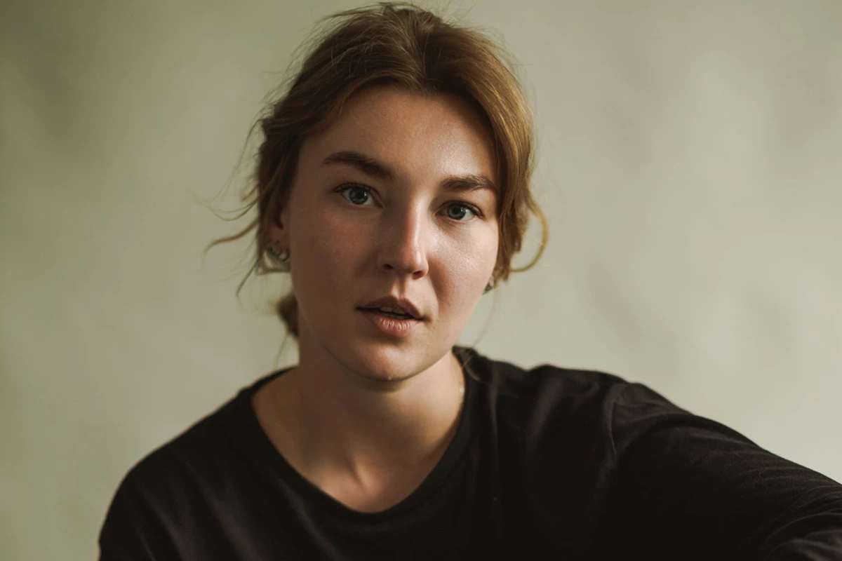 Woman with brown hair in black shirt.