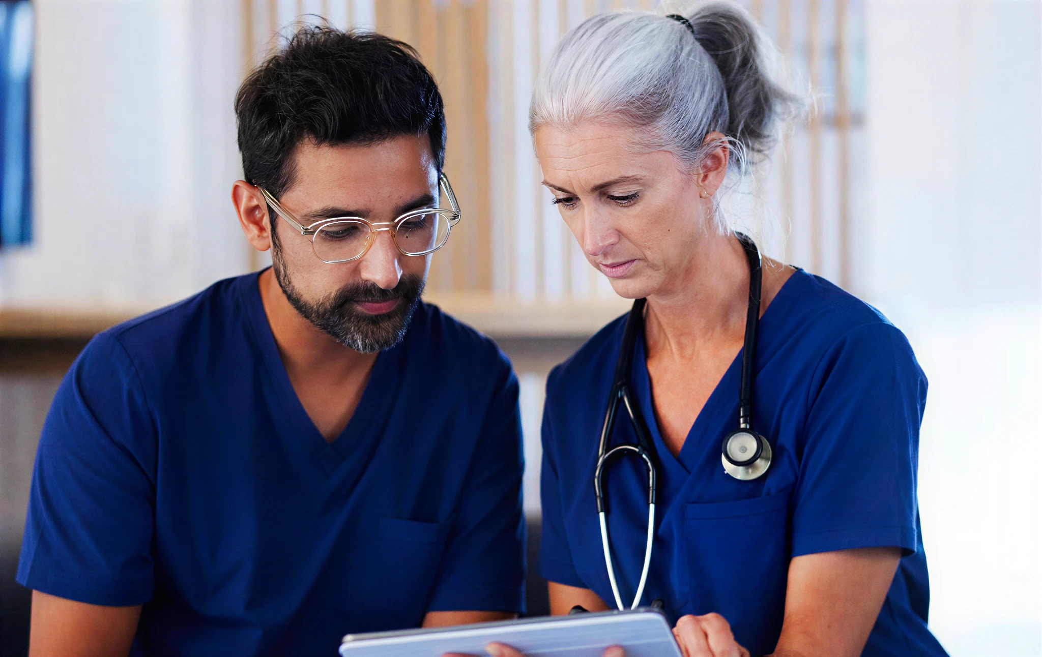 Doctors reviewing information on a tablet.