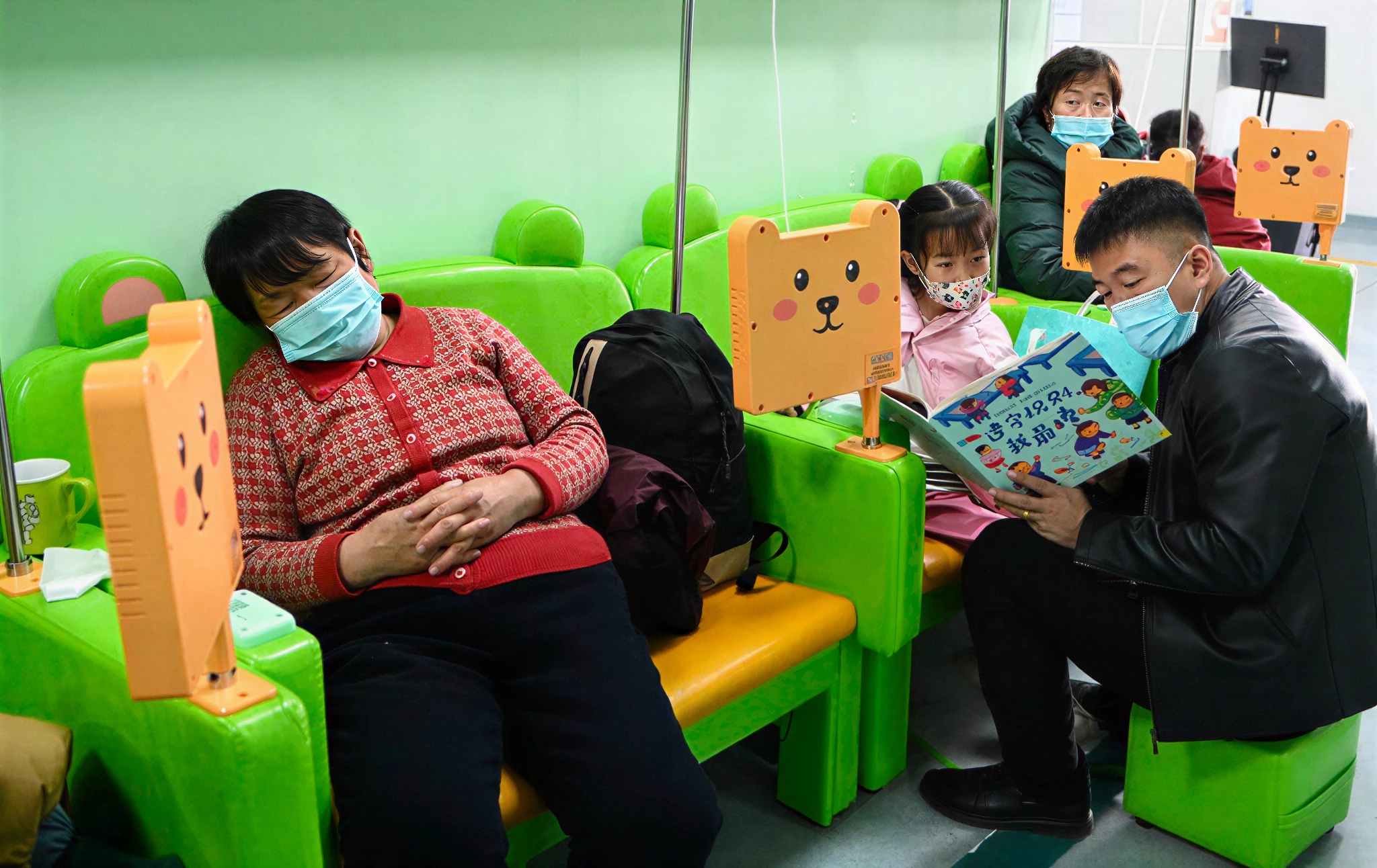 People wearing masks in a waiting room.