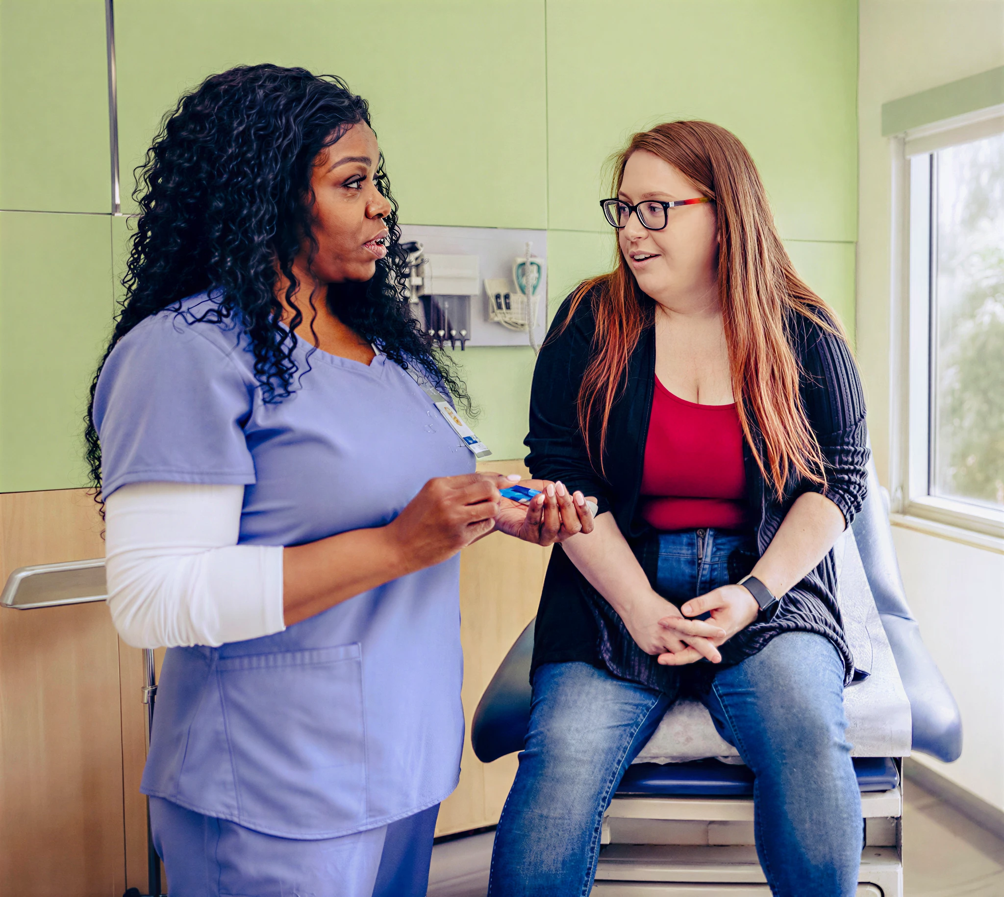Nurse consulting with patient in medical office.