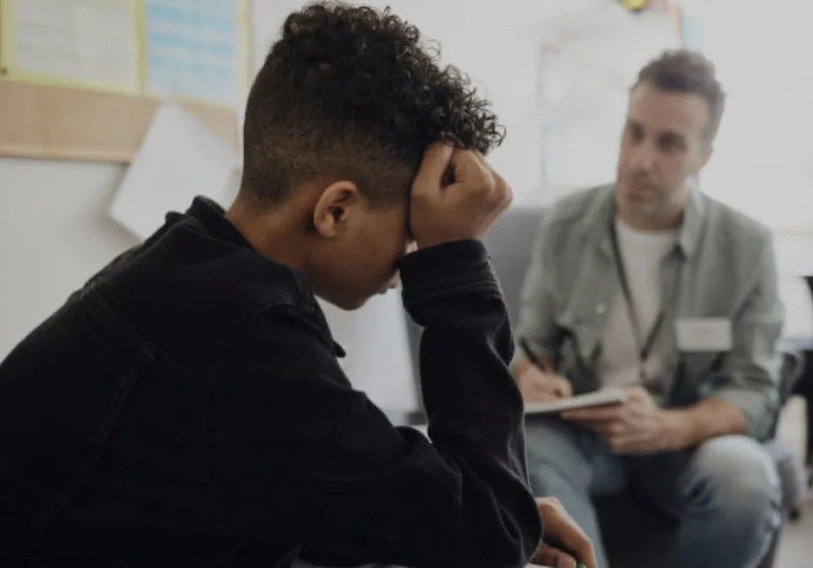 Teen in counseling session with therapist.